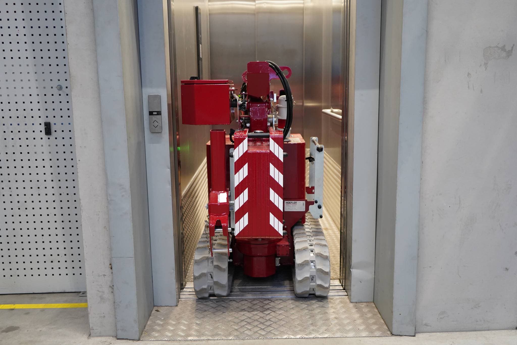 Bild des Hoeflon C1e Krans im Transportmodus in einem Aufzug.